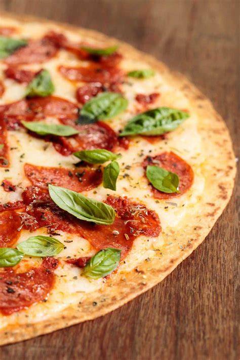 Pizza crust and toppings showing traditional thin crust
